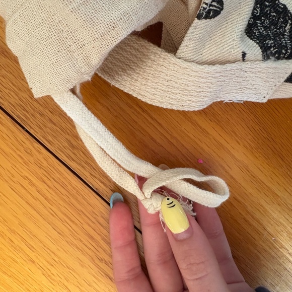 Draw string tote bag with adjustable strap, has an inscet print on both sides. - Picture 3 of 5